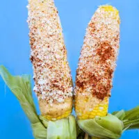 Tacomio Offering Elote (Mexican Street Corn on the Cob)