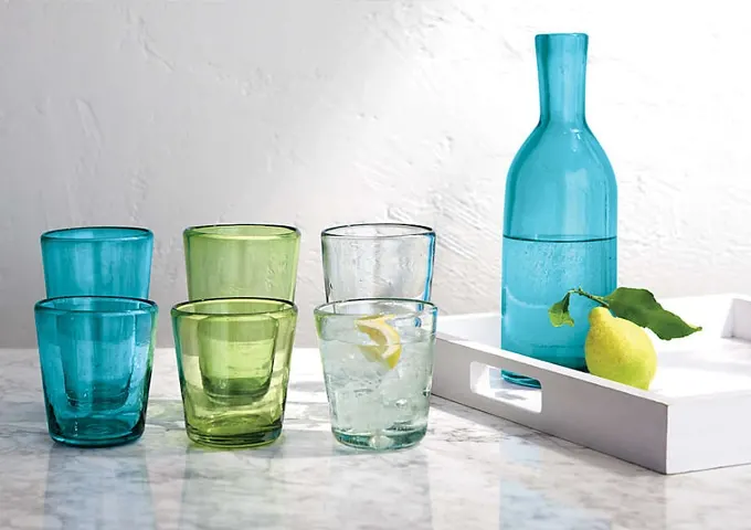 Rustic Mexican recycled glass with a bottle-green cast is handmade and hand-shaped into friendly, chunky barware for all-purpose beverage service. Miguel Glasses at Crate and Barrel, $5.95 - $6.95.