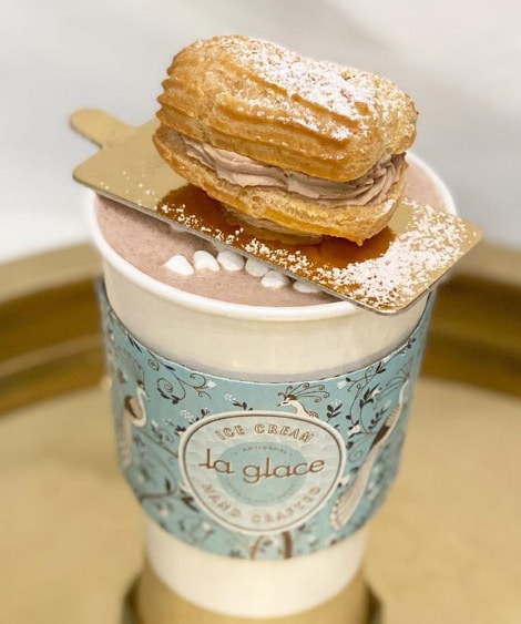 ÉCLAIR (takeout only). Available January 16 - February 14, 2021. Dark Valrhona hot chocolate. Served with a mini frozen whipped ganache éclair.