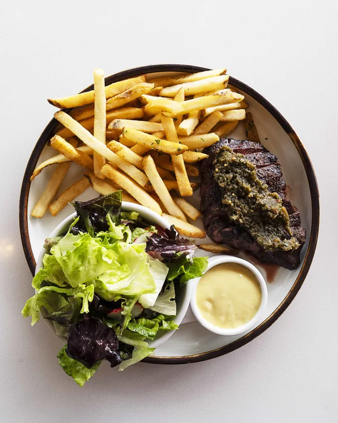 A 6oz flat iron grilled steak with caramelized garlic aioli, pickled ramp chimichurri and red wine demi glace accoutrements.