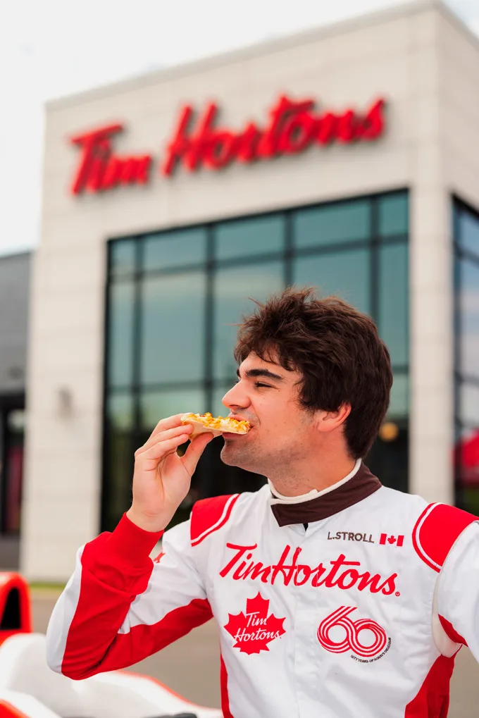 Canadian Formula One driver Lance Stroll goes on a unique Tims Run with a Tim Hortons-branded race car at a hometown Tims drive-thru in Montreal